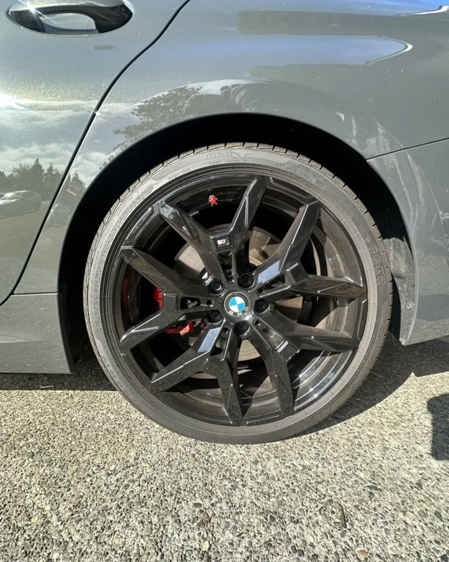 Dark wheel on a grey car after cleaning